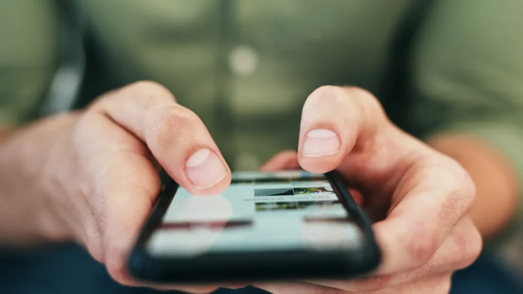 A Person Holding A Cell Phone