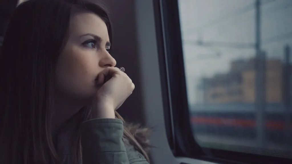 A Woman Looking Out A Window